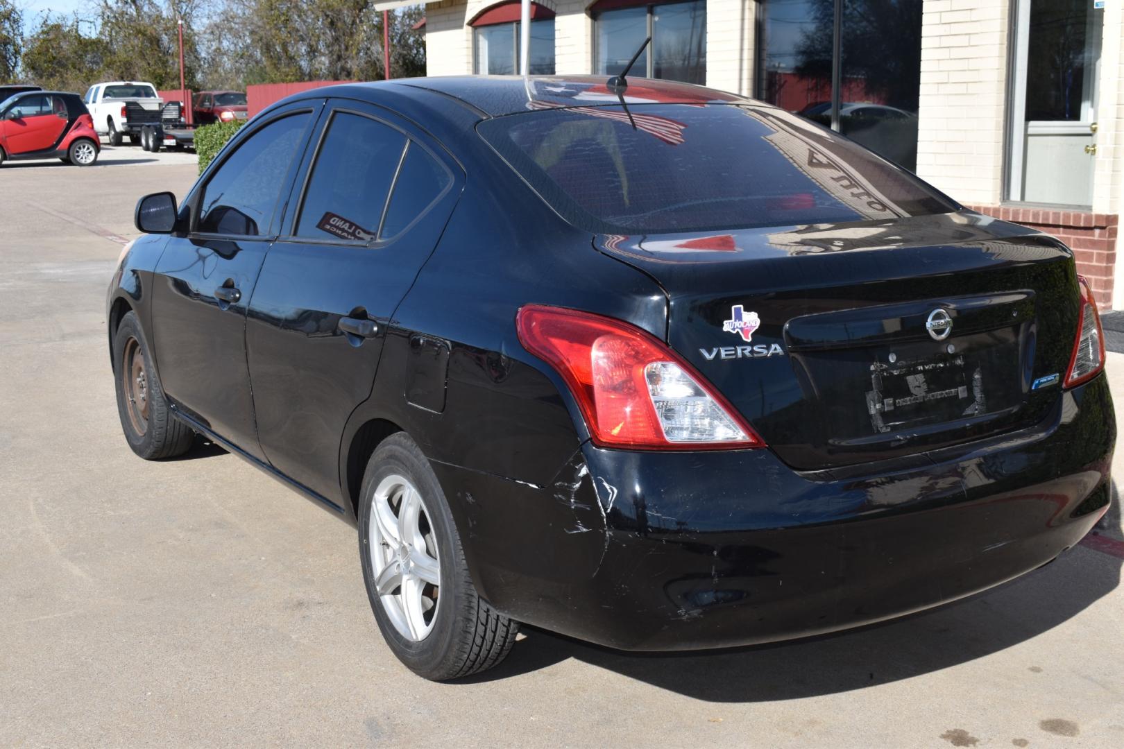 2014 Black /Black Nissan Versa 1.6 S 5M (3N1CN7AP2EL) with an 1.6L L4 DOHC 16V engine, CVT transmission, located at 5925 E. BELKNAP ST., HALTOM CITY, TX, 76117, (817) 834-4222, 32.803799, -97.259003 - The 2014 Nissan Versa 1.6 S 5M offers several benefits, including its fuel efficiency, spacious interior, and affordable price tag. It's also known for its reliability and low maintenance costs, making it a practical choice for budget-conscious buyers. Additionally, its simple yet functional design - Photo#2